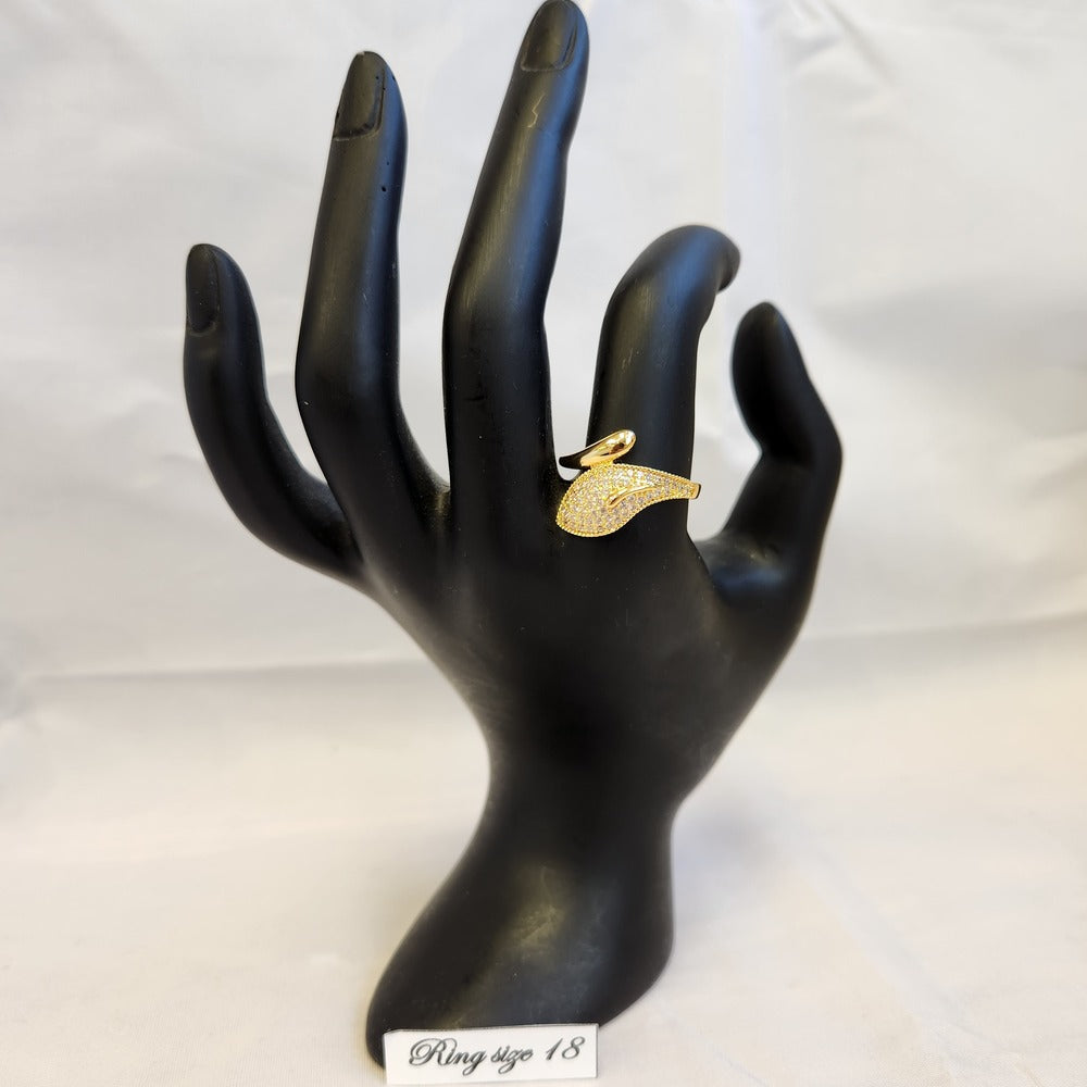 Gold frame ring set with clear stones displayed on a mannequin stand