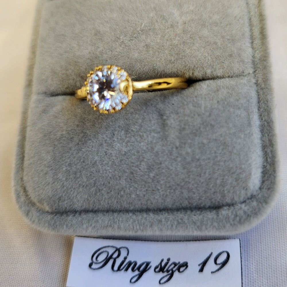 Detailed view of simple halo style gold frame ring