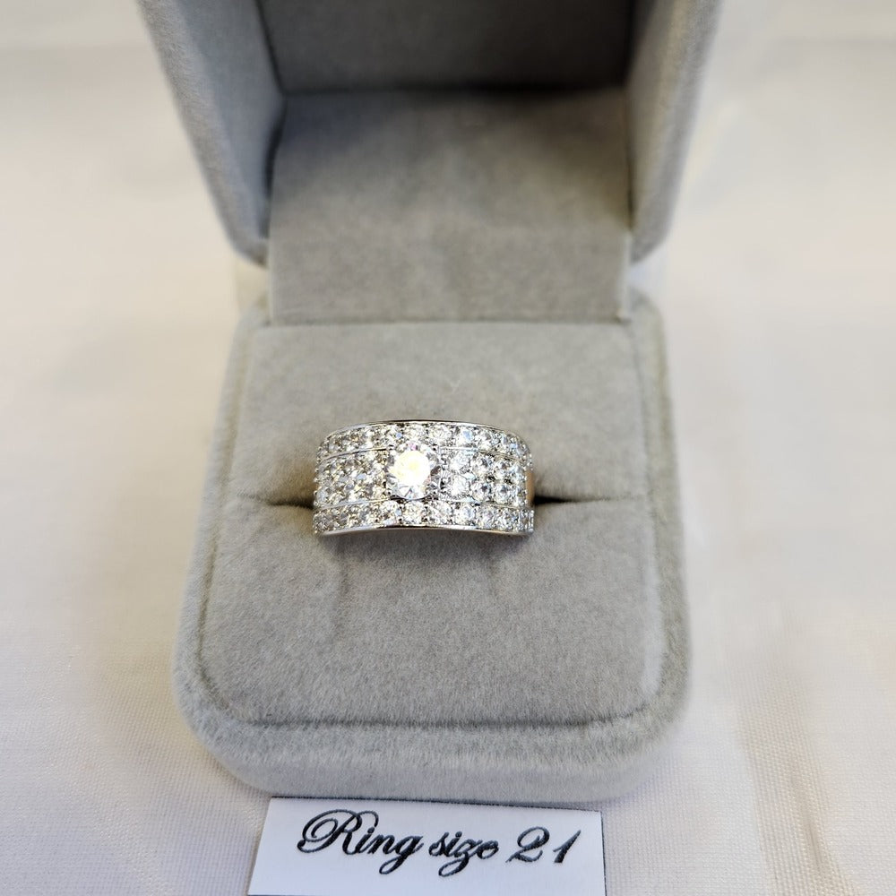 Wide gold band ring with dazzling stone setting