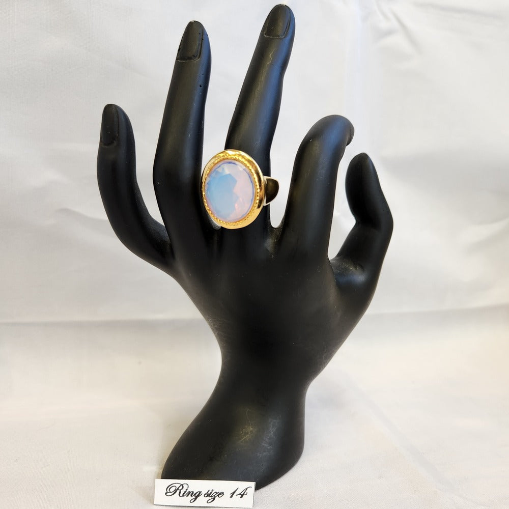 Ring with AB color center stone displayed on a mannequin stand