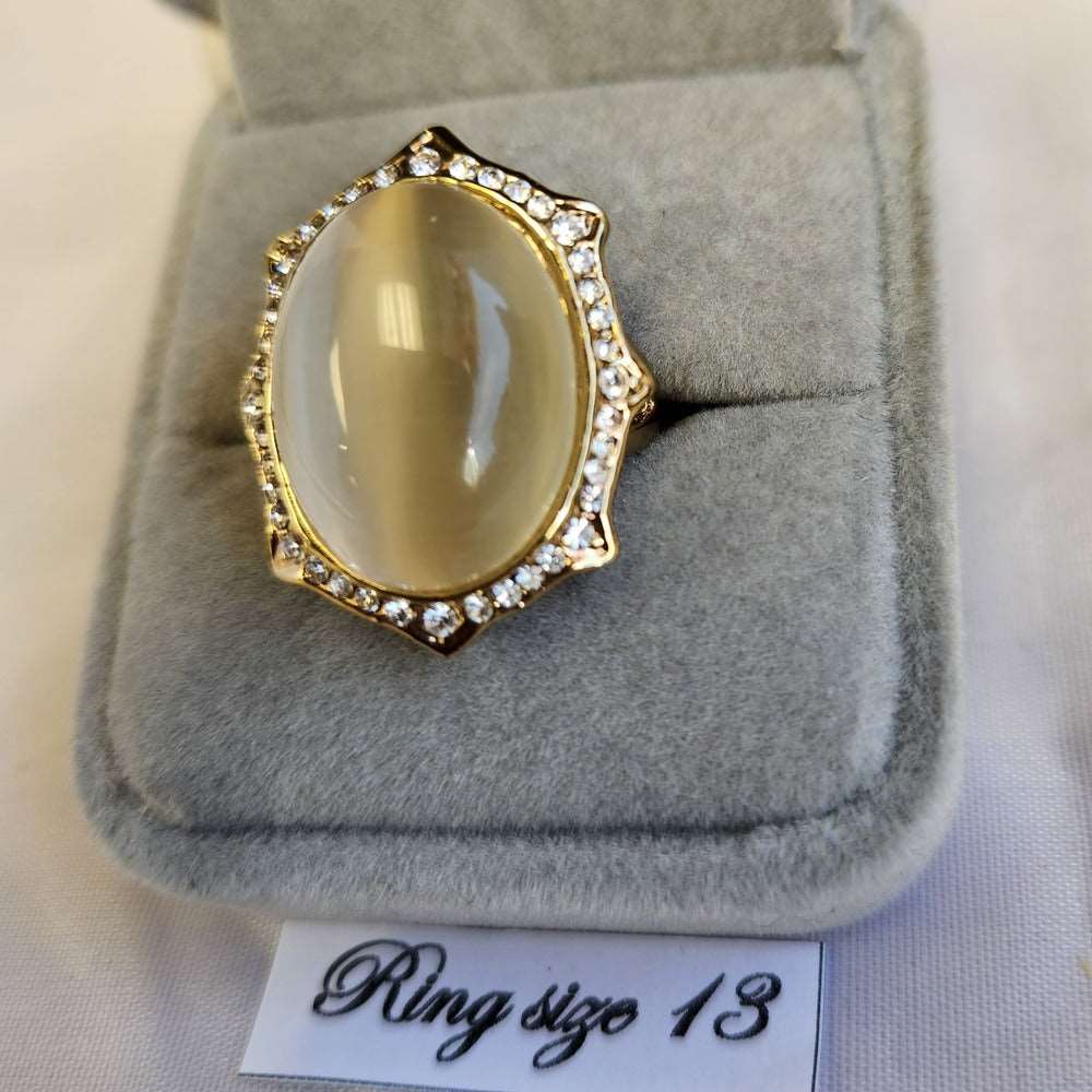 Detailed view of bold ring with cobochon cut center stone