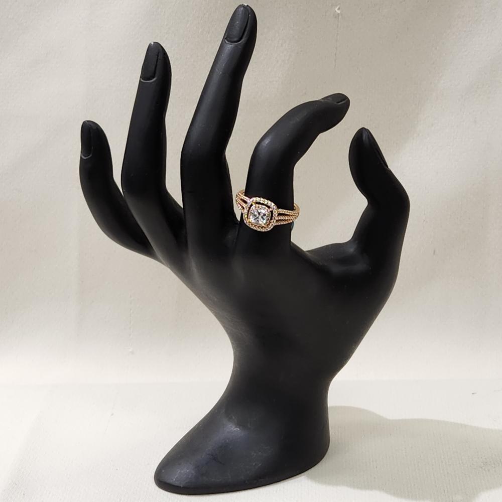Gold color ring with clear cushion-set center stone