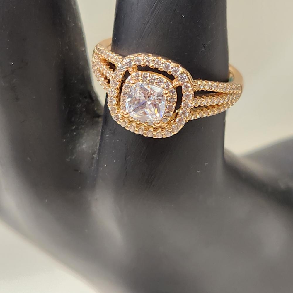 Detailed front view of Gold color ring with clear cushion-set center stone