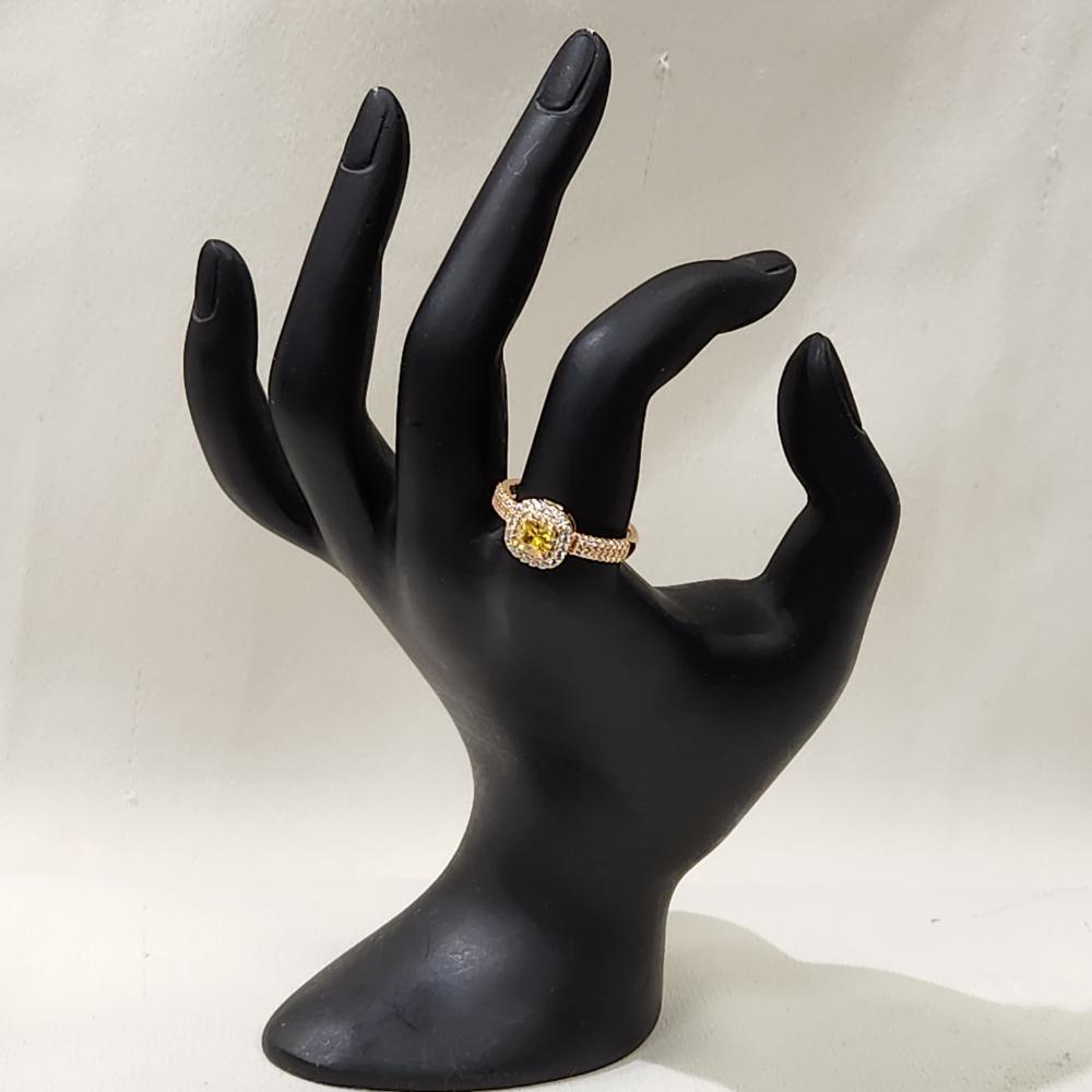 Gold color ring with square shaped yellow center stone