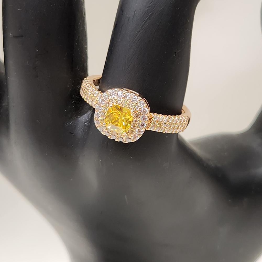 Front detailed view of Gold color ring with square shaped yellow center stone
