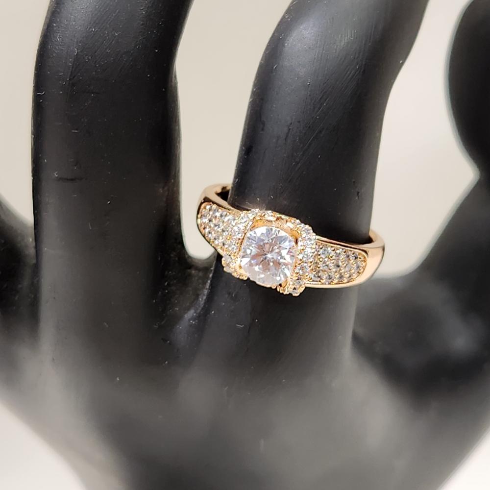 Detailed front view of Exquisite gold color ring with round center stone