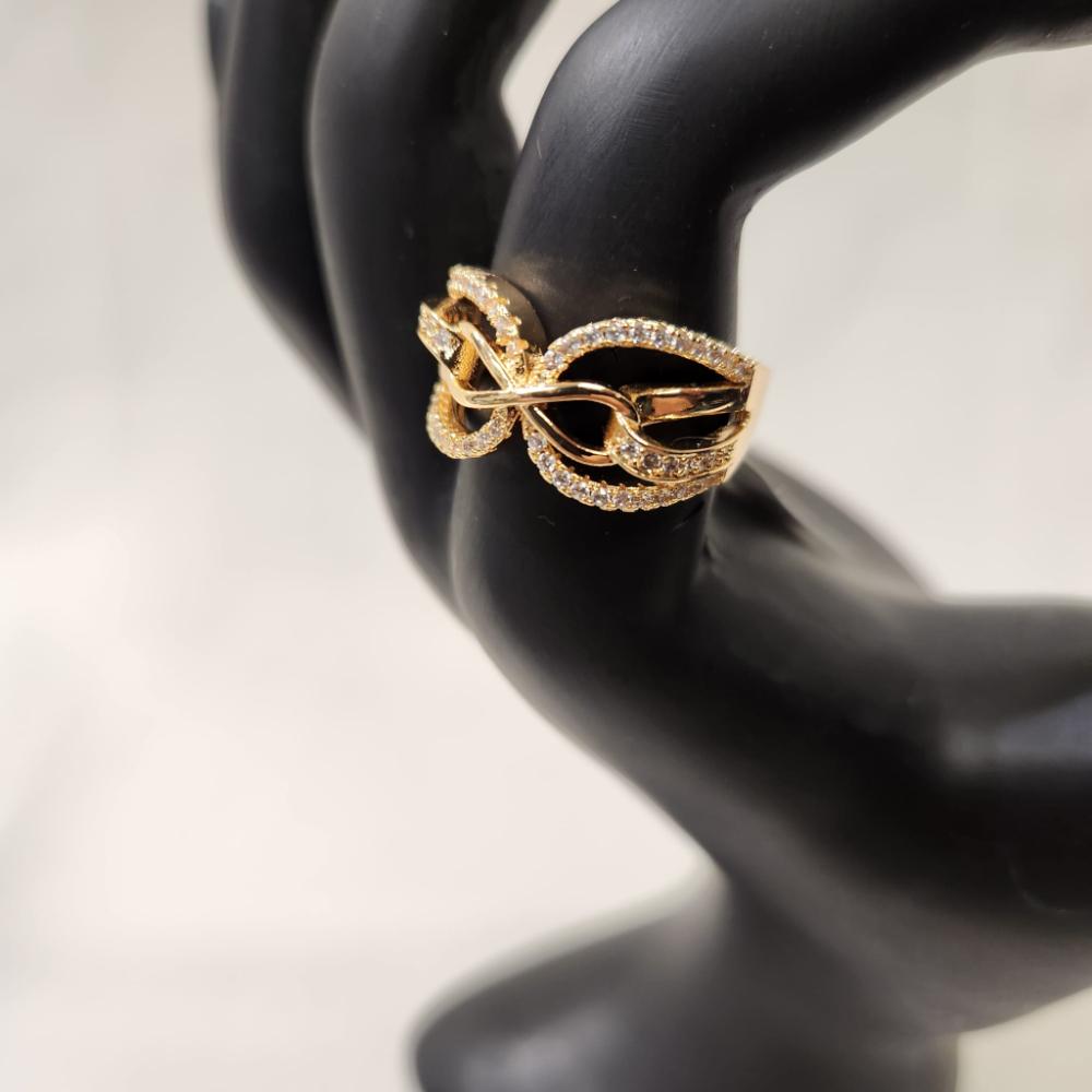 Detailed view of Infinity gold hued ring with cubic zirconia