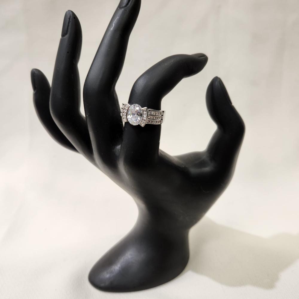 Silver hued ring with round center stone