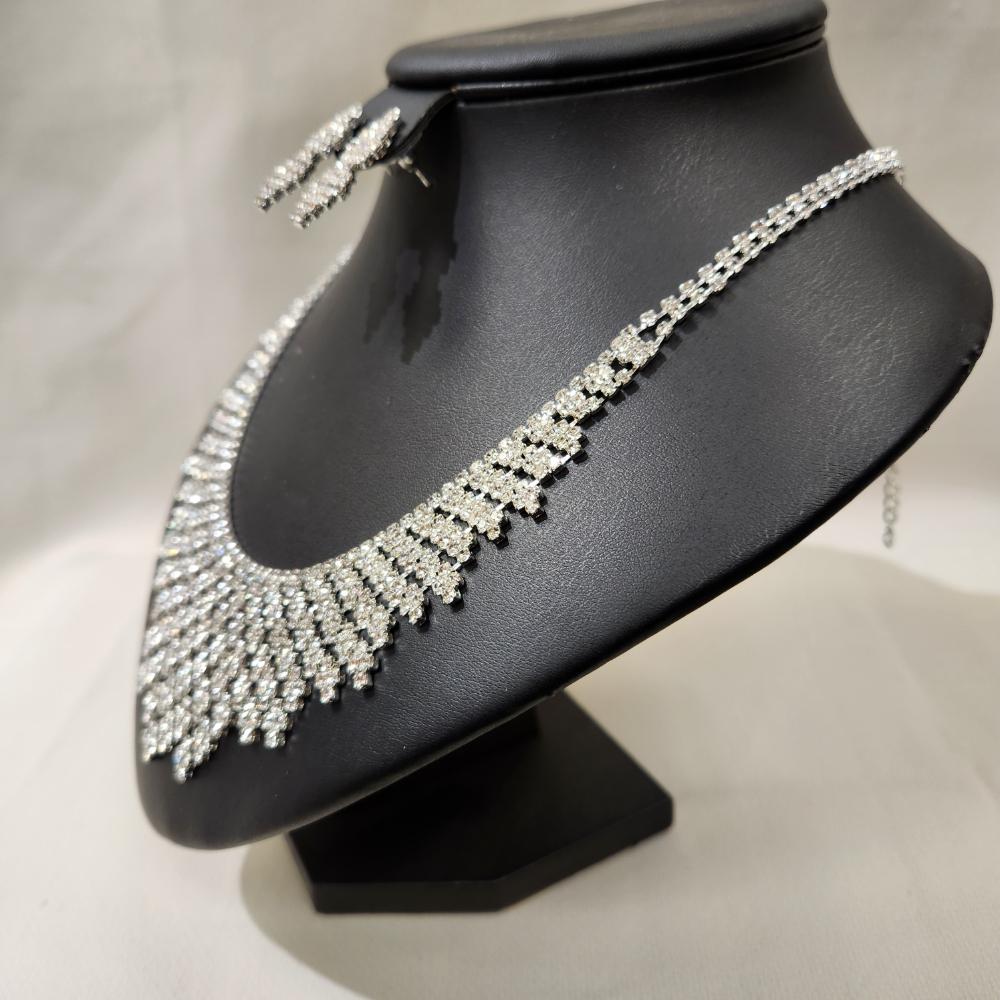 Side view of silver tone three piece jewelry set