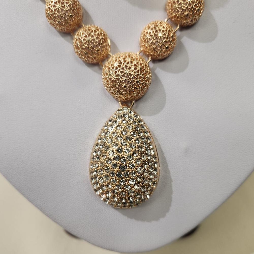 Detailed view of tear drop shaped center piece of the necklace