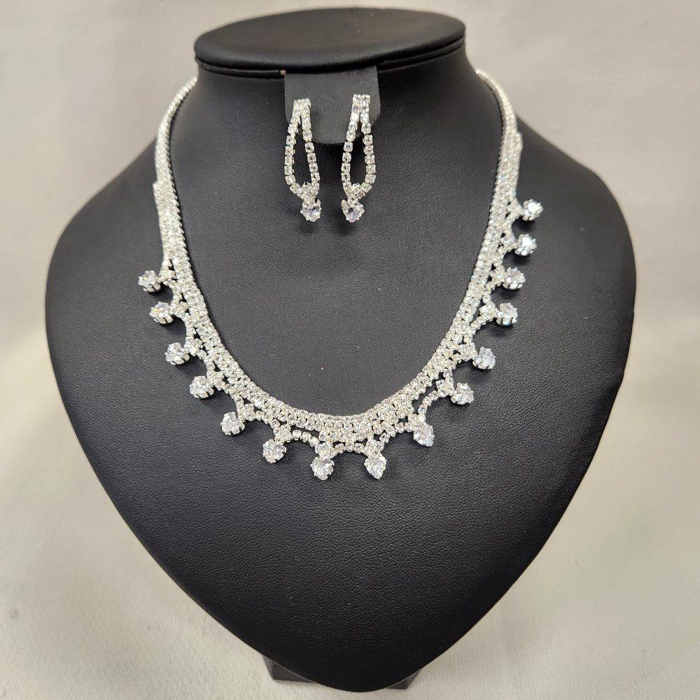 Silver hued three piece jewelry set adorned with stones