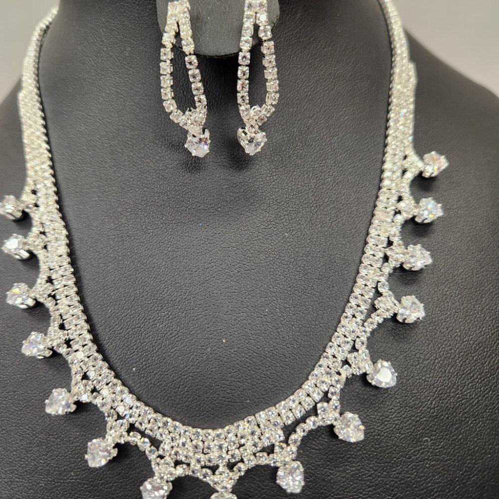 Detailed view of Silver hued three piece jewelry set
