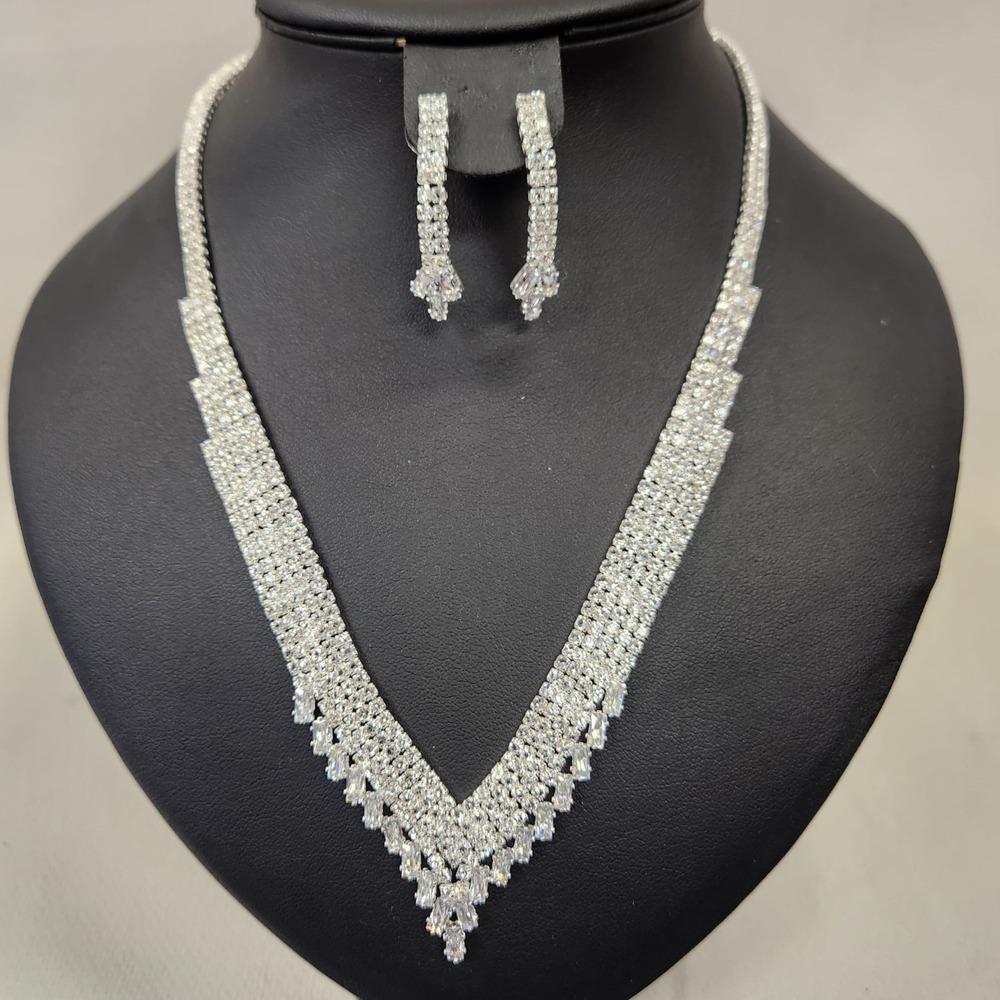 Three piece jewelry set with stones in silver color frame