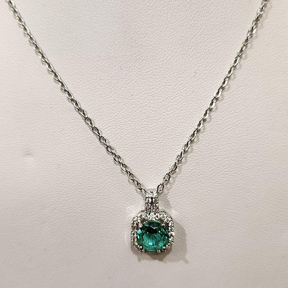 Detailed view of pendant with silver colored chain