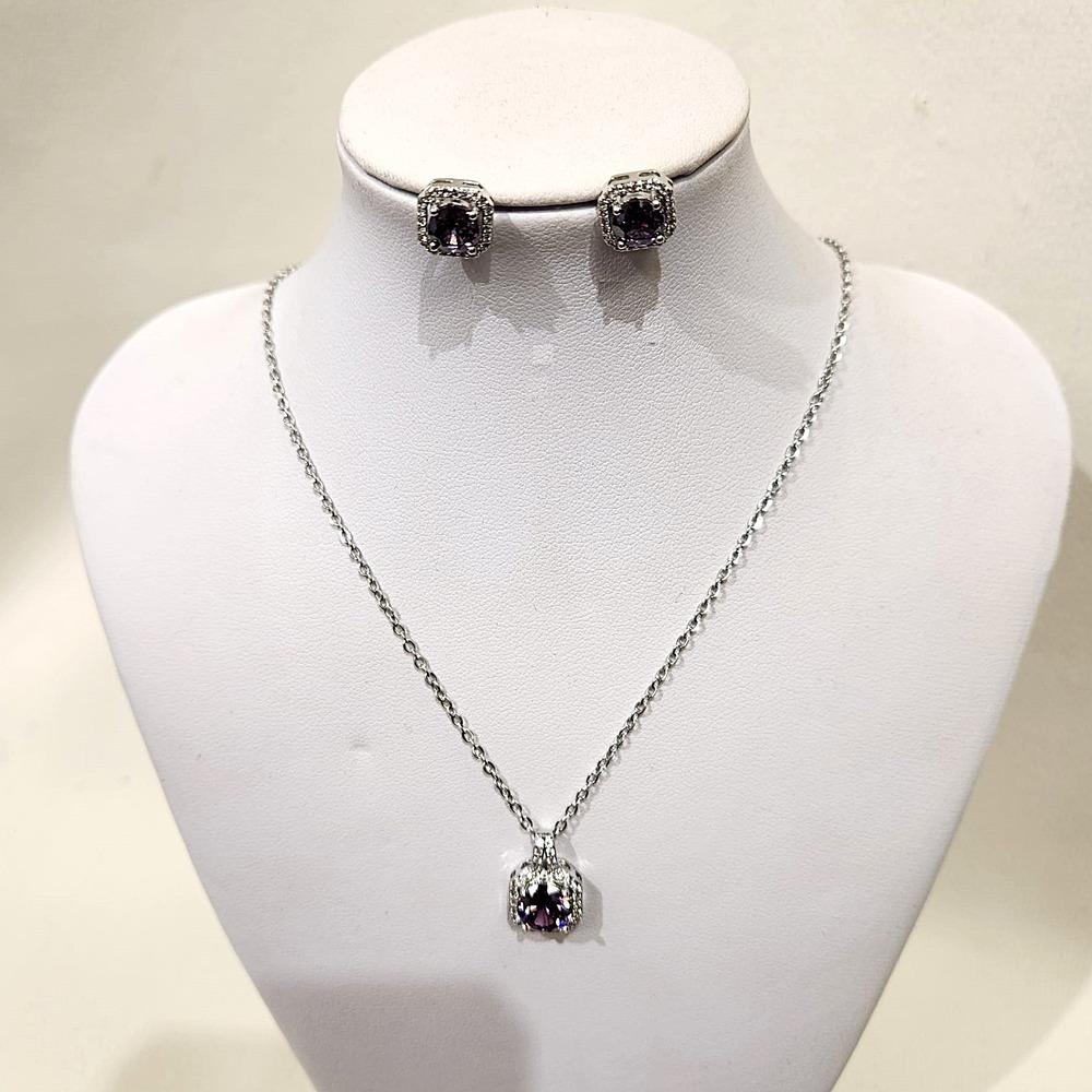 Three piece jewelry set with violet and clear stones