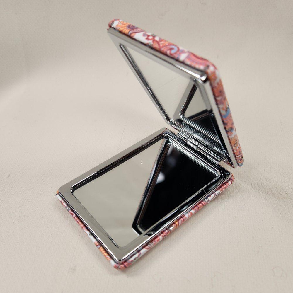 Rectangular pocket mirror in colorful when opened