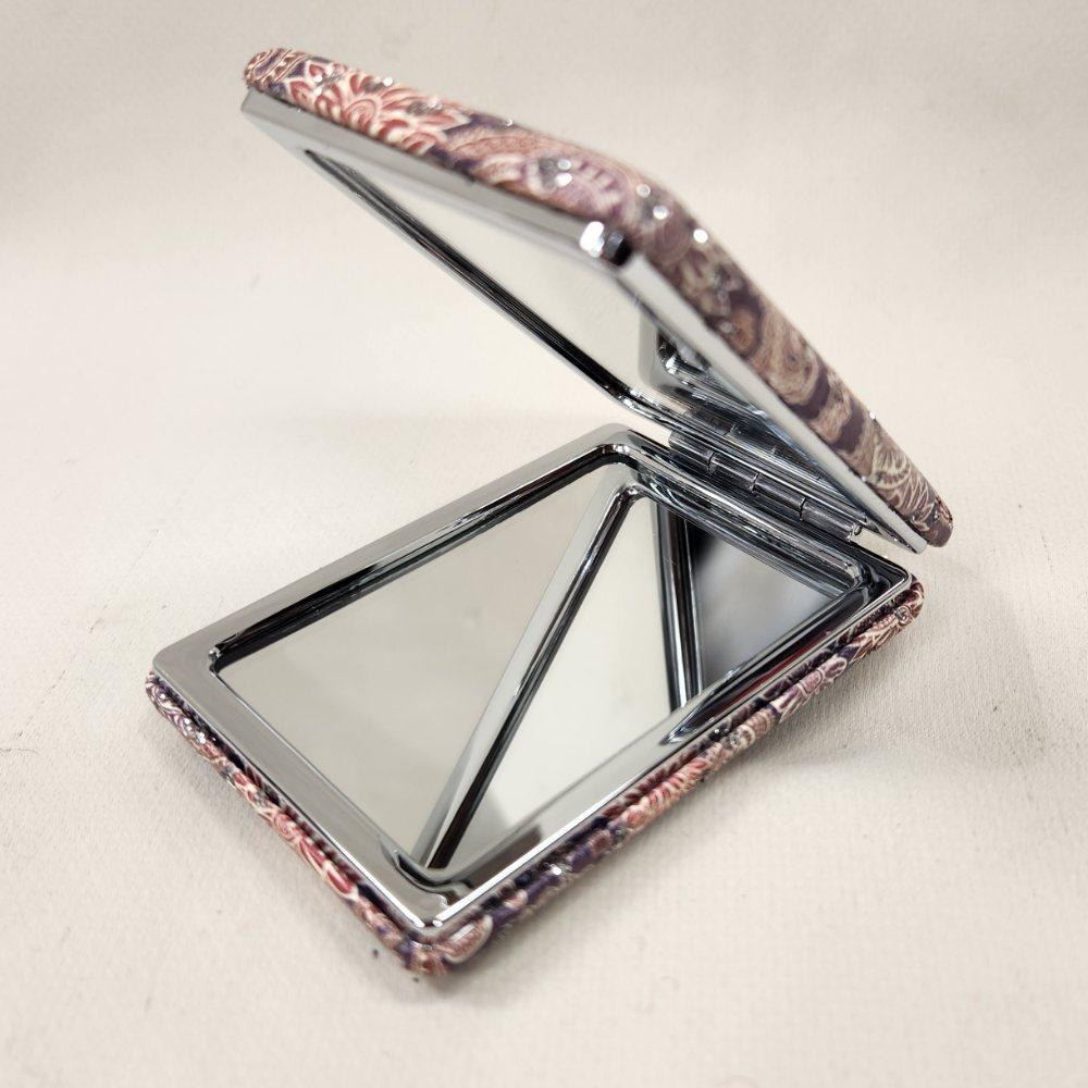 Colorful pocket mirror in ethnic paisley pattern when opened