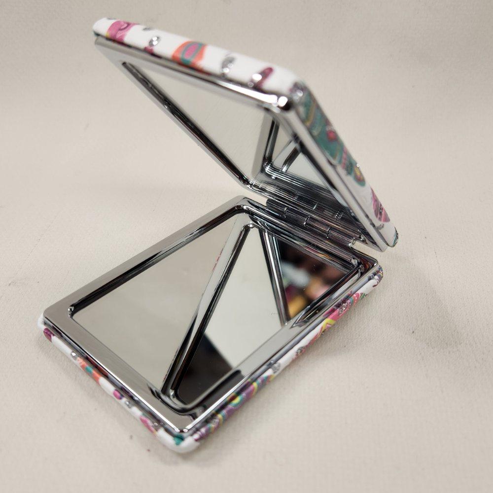 Pocket mirror in vibrant feather print when opened