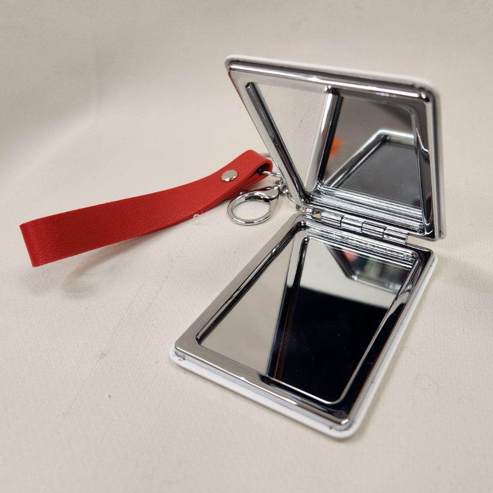 Pocket mirror with keyring when opened