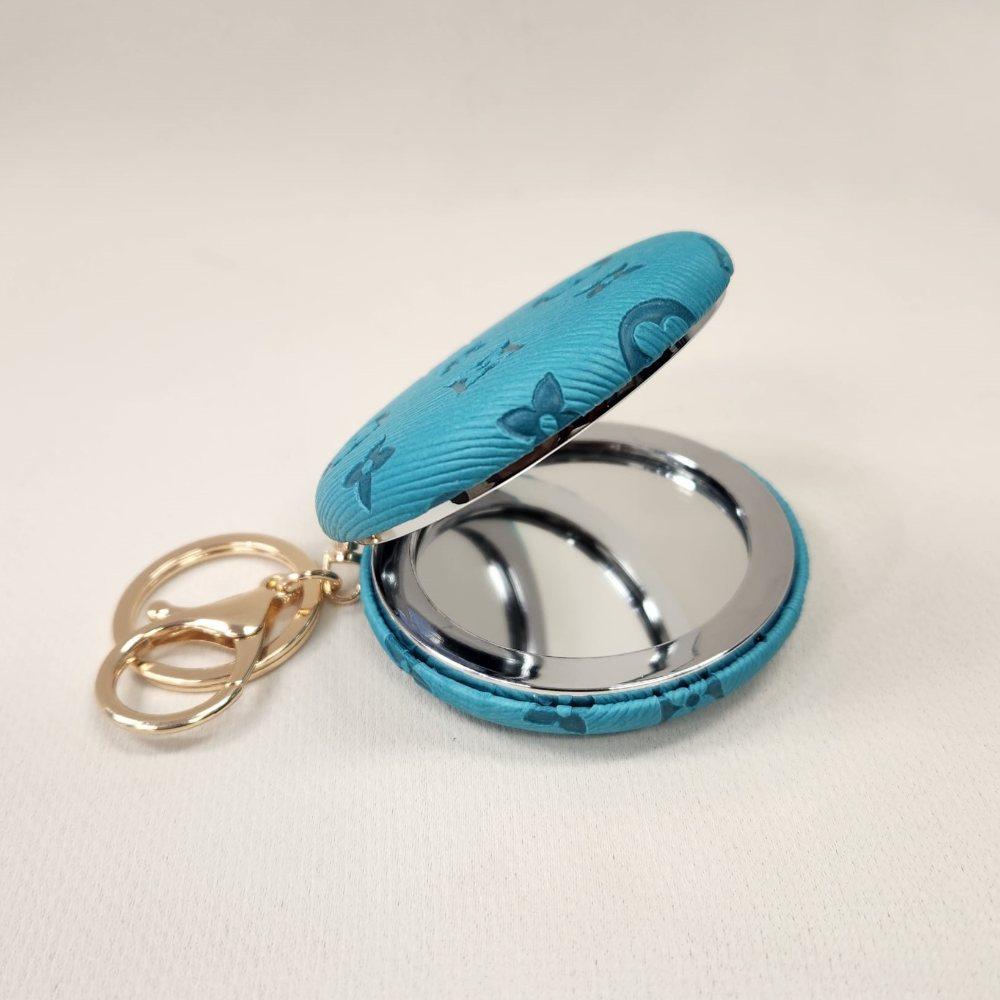 Turquoise Pocket mirror with engraved floral pattern and a keyring when opened