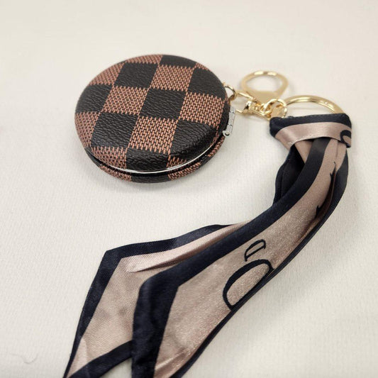 Pocket mirror with brown checkered print and a keyring when closed