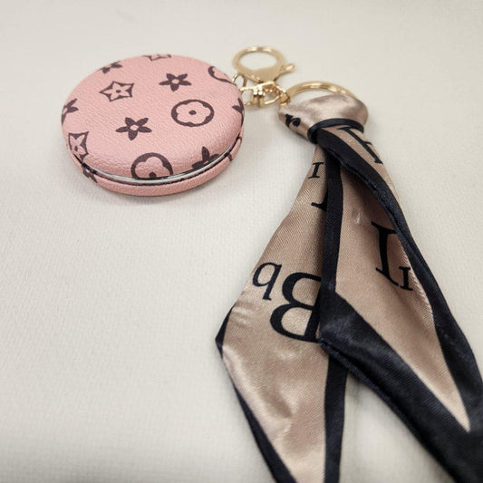 Pink Pocket mirror with brown floral pattern and a keyring when closed