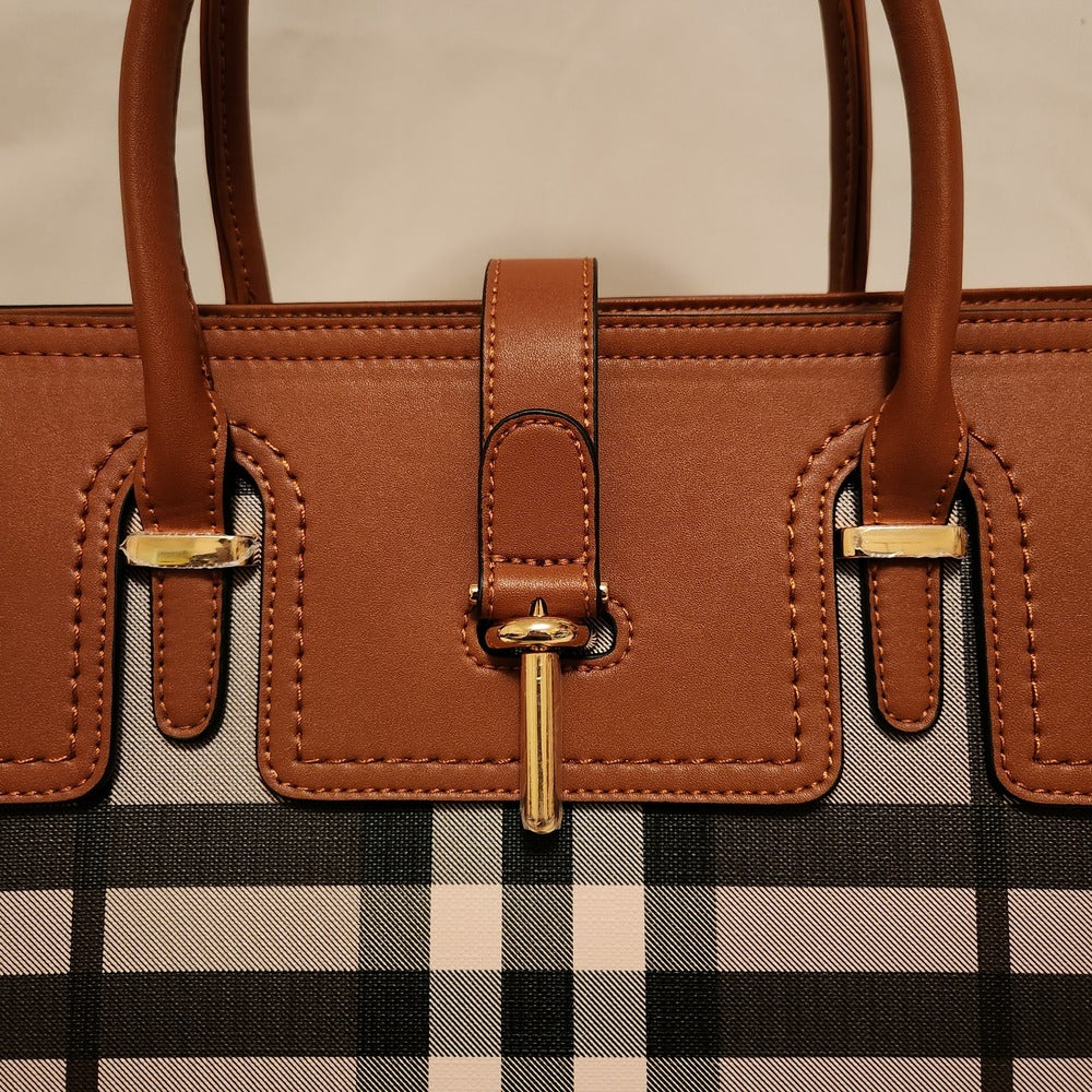 Detailed view of gold hardware on patterned handbag
