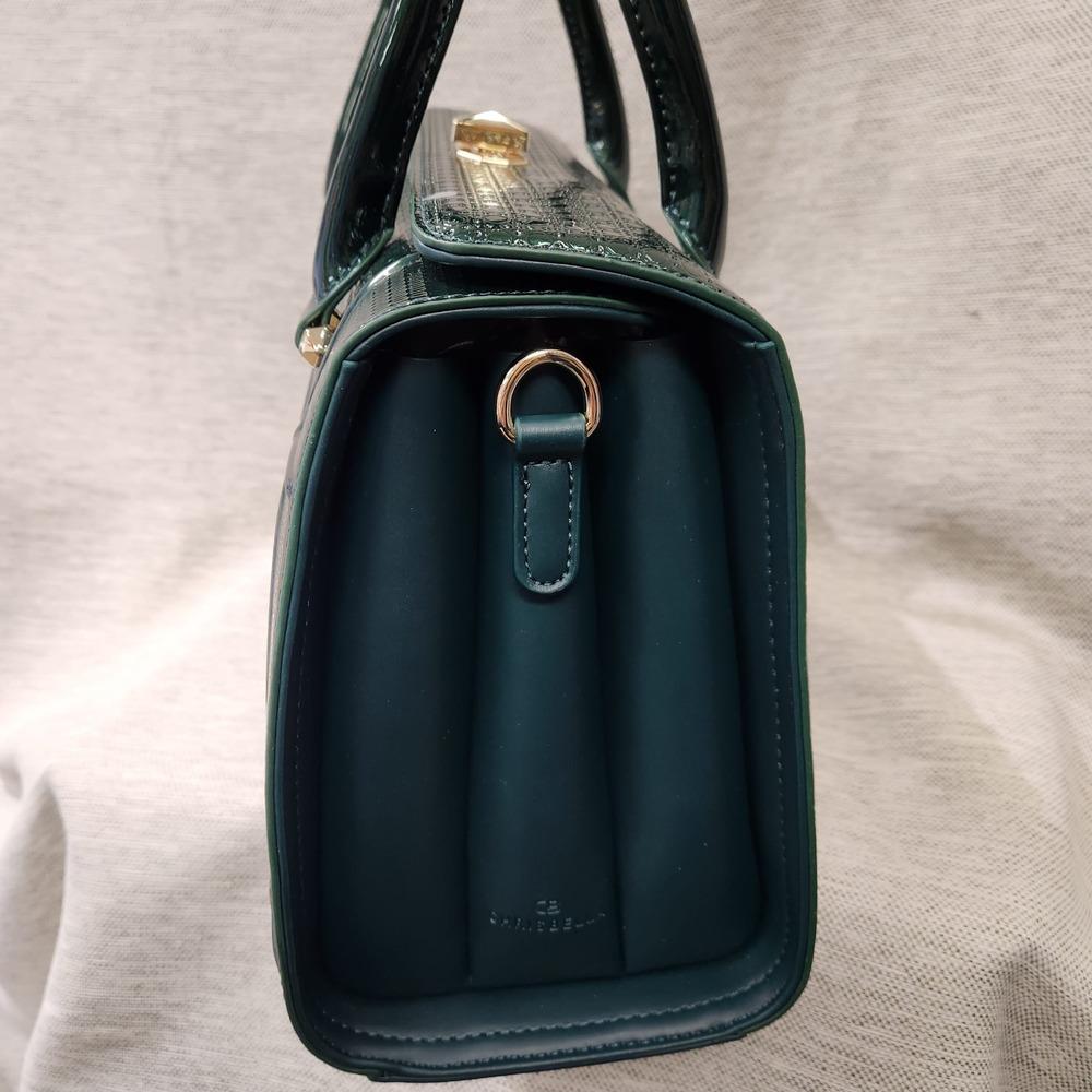 Side view of Green patent Fold-top handbag