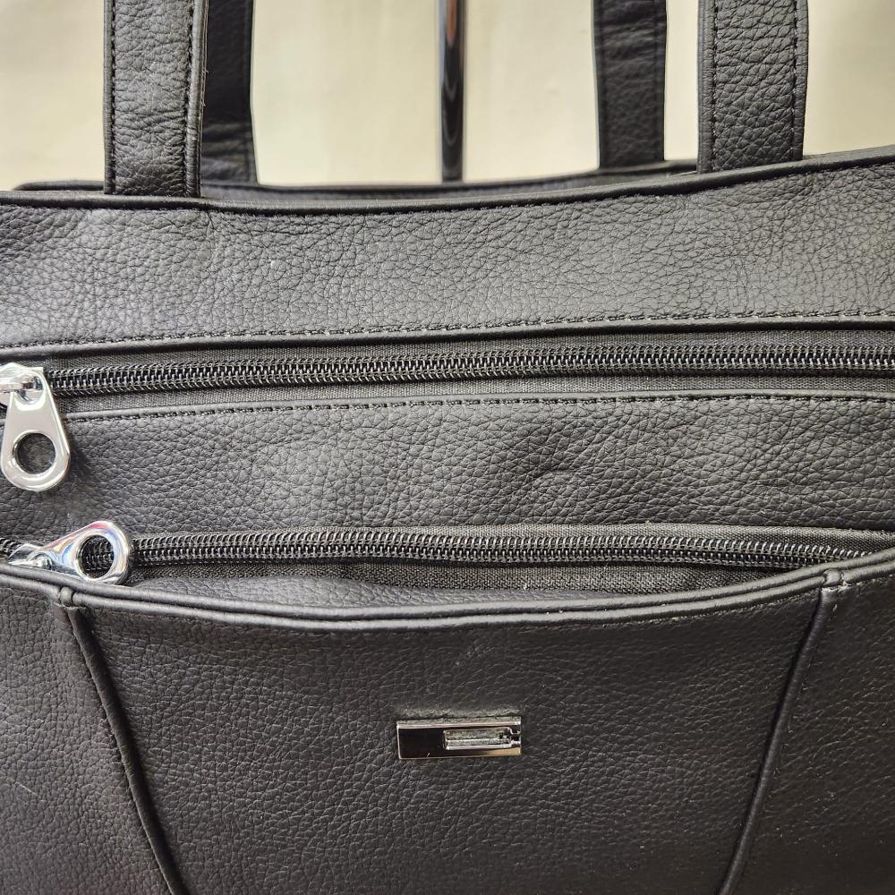 Detailed front view of Multi compartment black handbag for women
