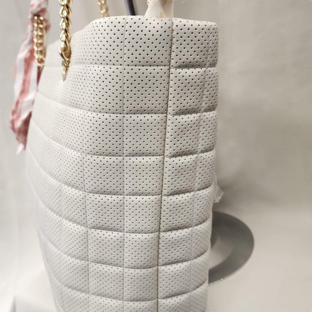 Side view of elegant off white handbag