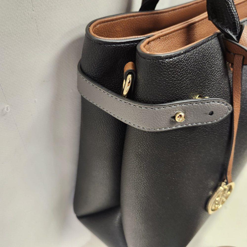 Another side view of Black handbag with tan and grey accent colors