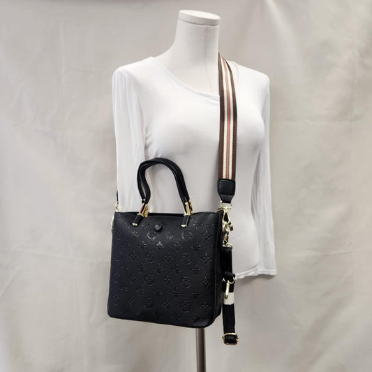 Black color handbag with embossed graphic print