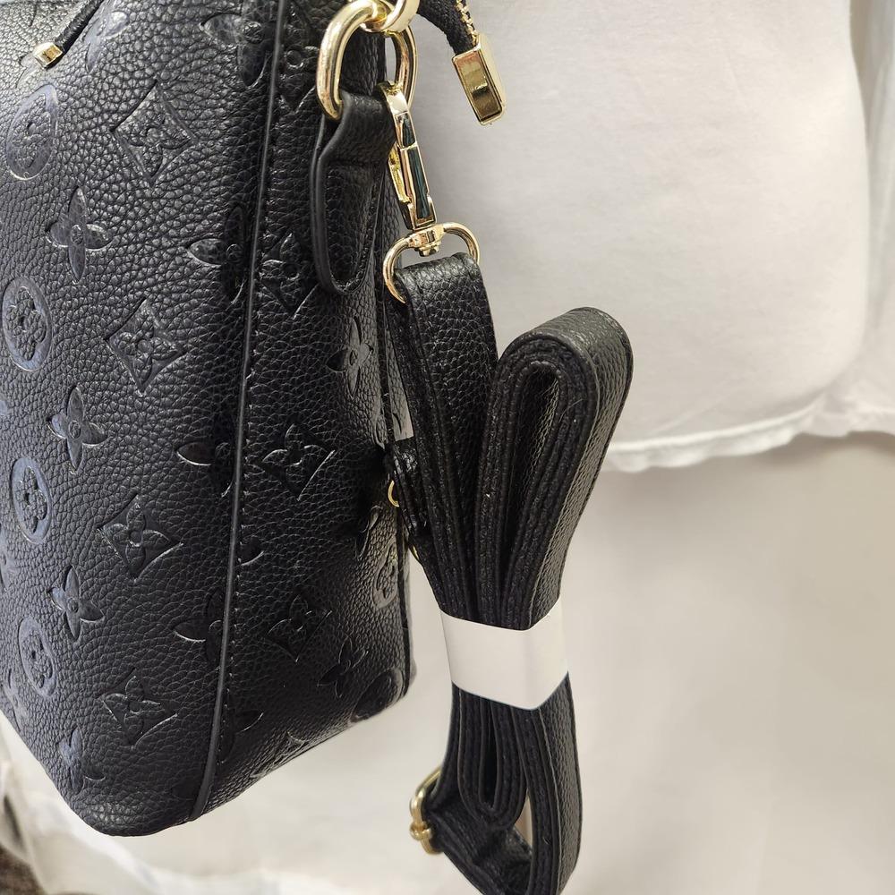 View of black adjustable and removable shoulder strap