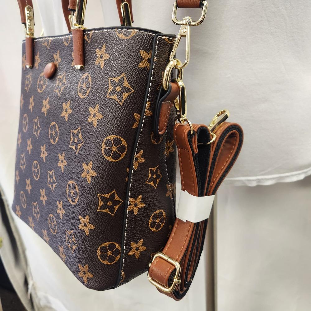 Side view of Brown handbag with tan graphic print