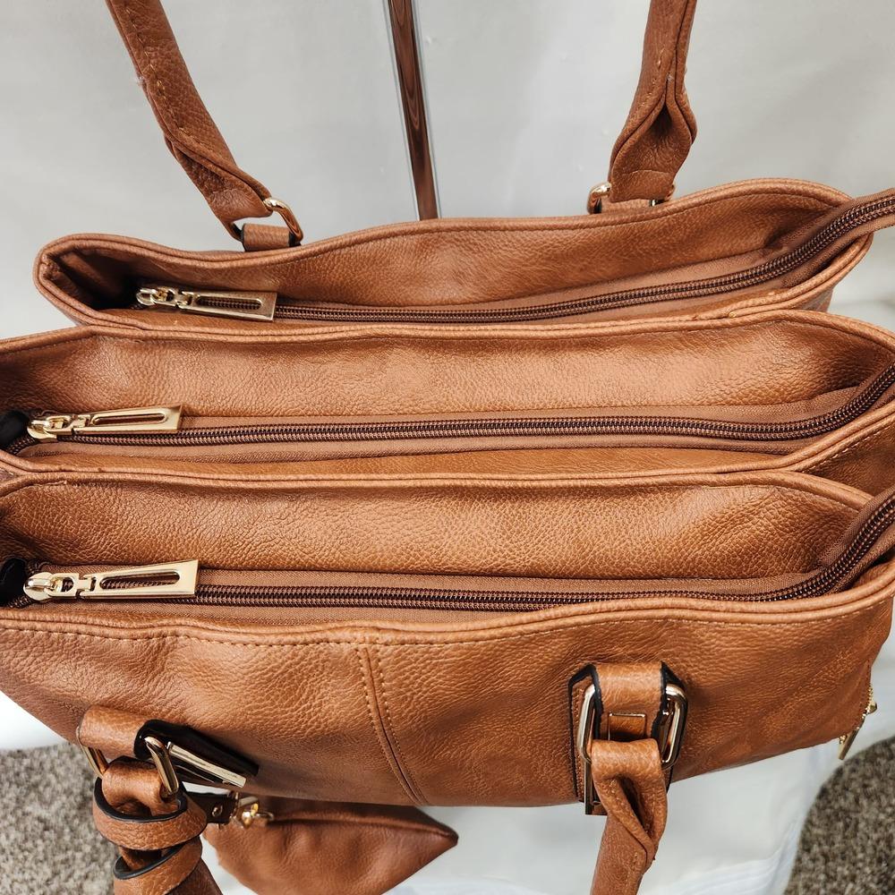 Triple main compartments of tan handbag