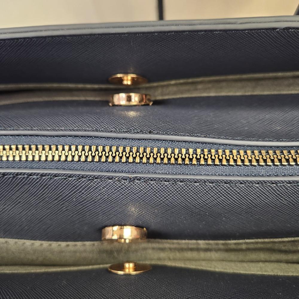 Top view of three major compartments of navy blue bag