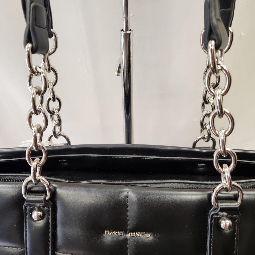 Detailed view of shoulder strap with silver chain