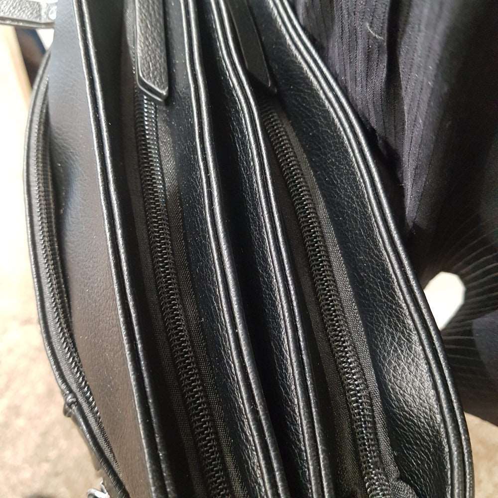 Top view of zipper compartments of black side bag