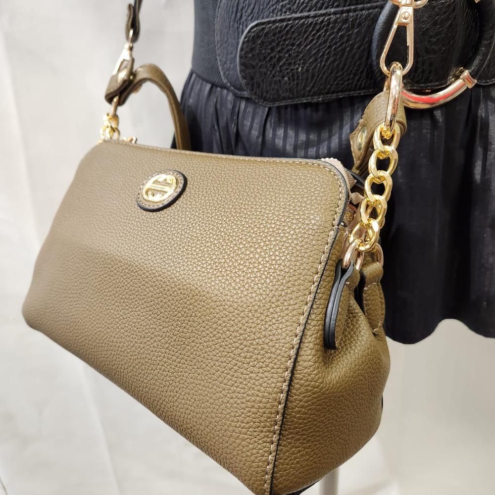 Detailed view of army green side bag with two straps