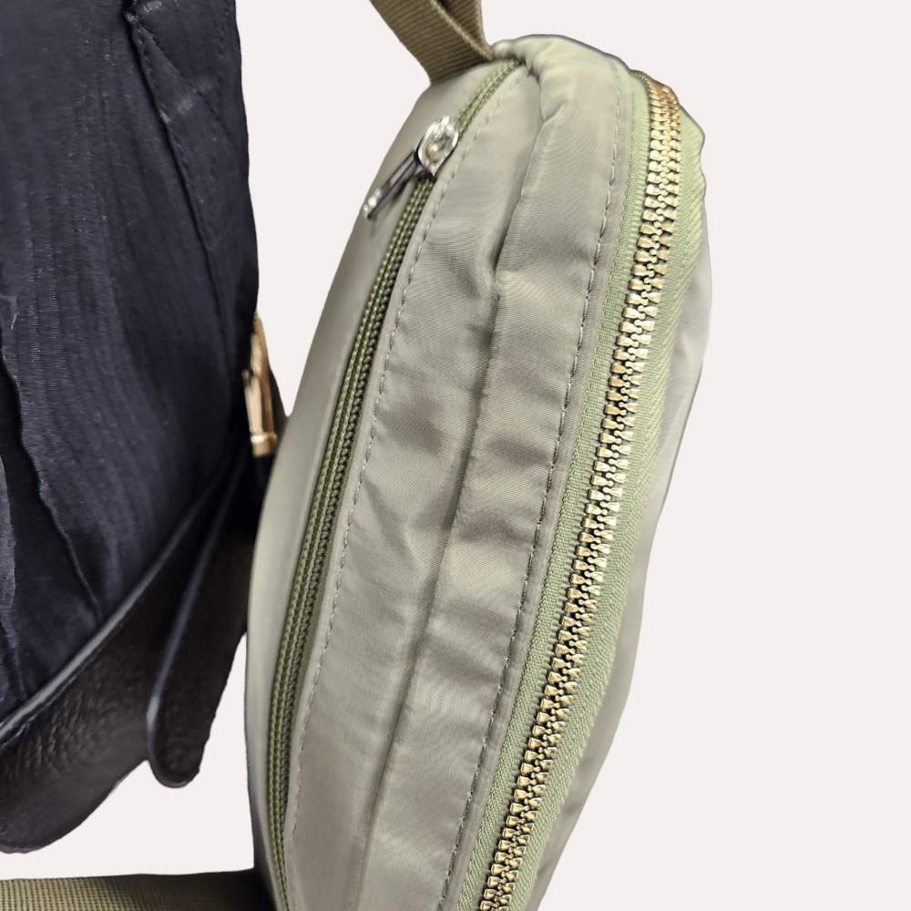 Gold color hardware on light green side bag