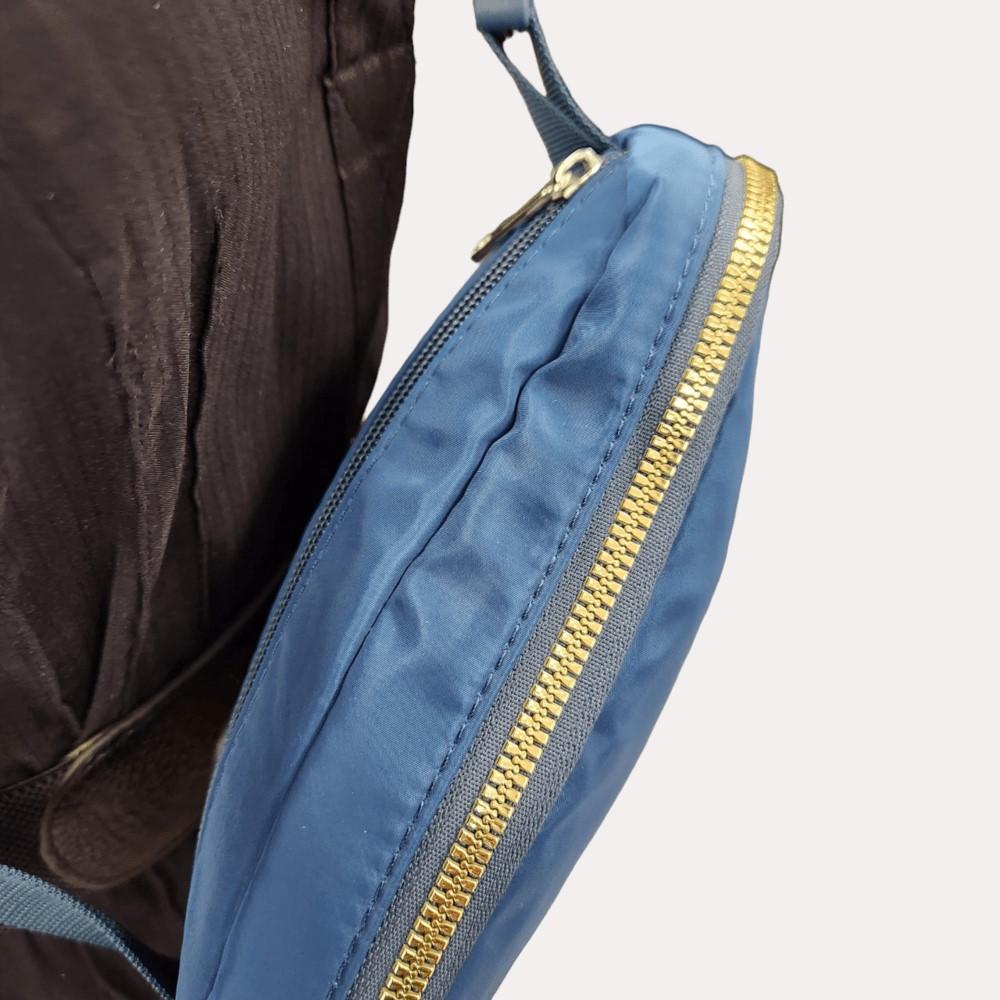 Gold hardware of blue microfiber side bag
