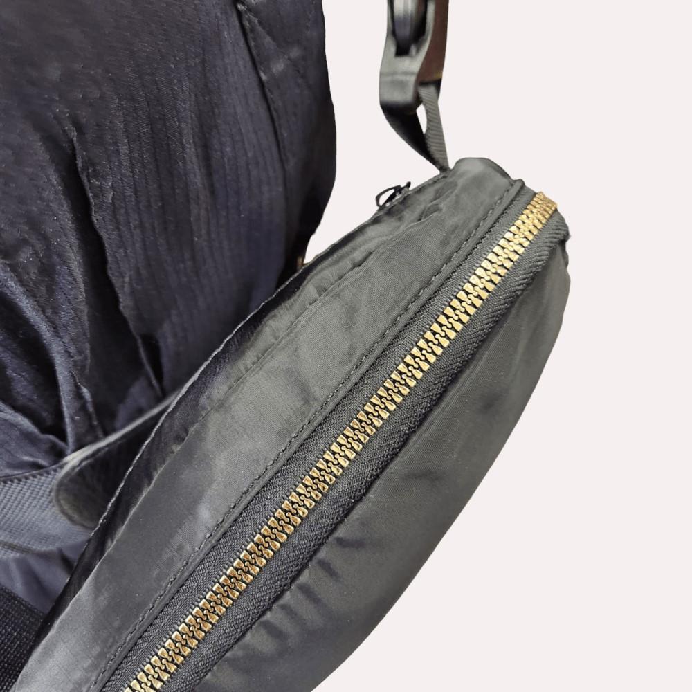 Gold hardware on black microfiber side bag
