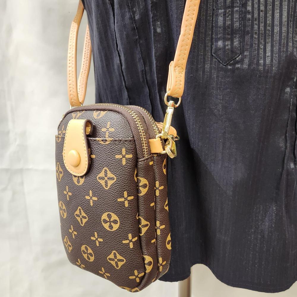 Detailed view of small floral pattern side bag with beige strap