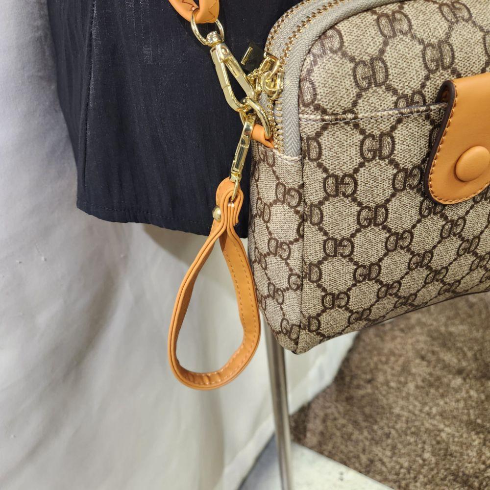 Tan wristlet on small side bag