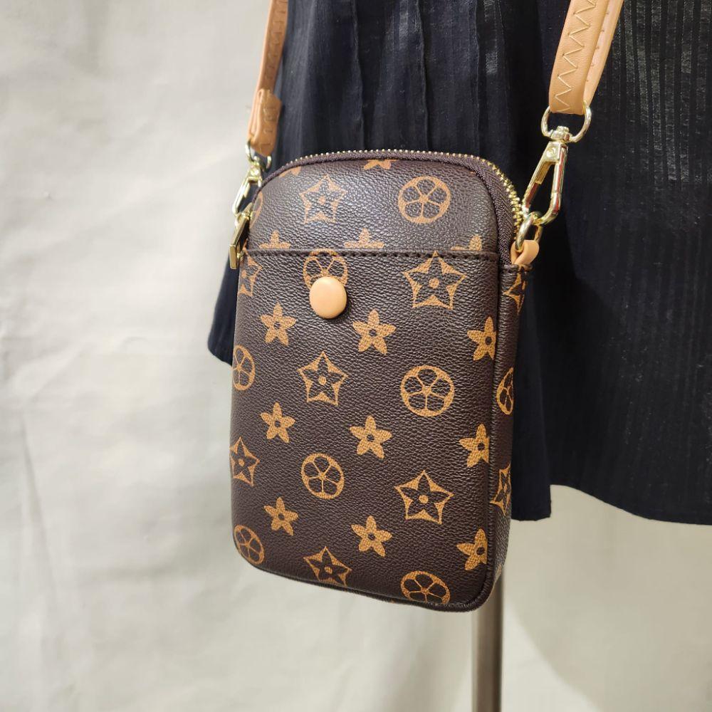 Detailed view of Small brown floral pattern side bag with beige strap