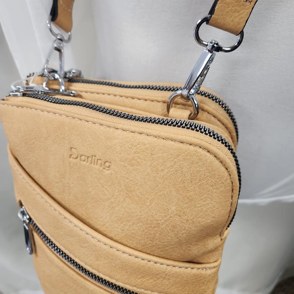 Double main zipped compartments of tan colored side bag