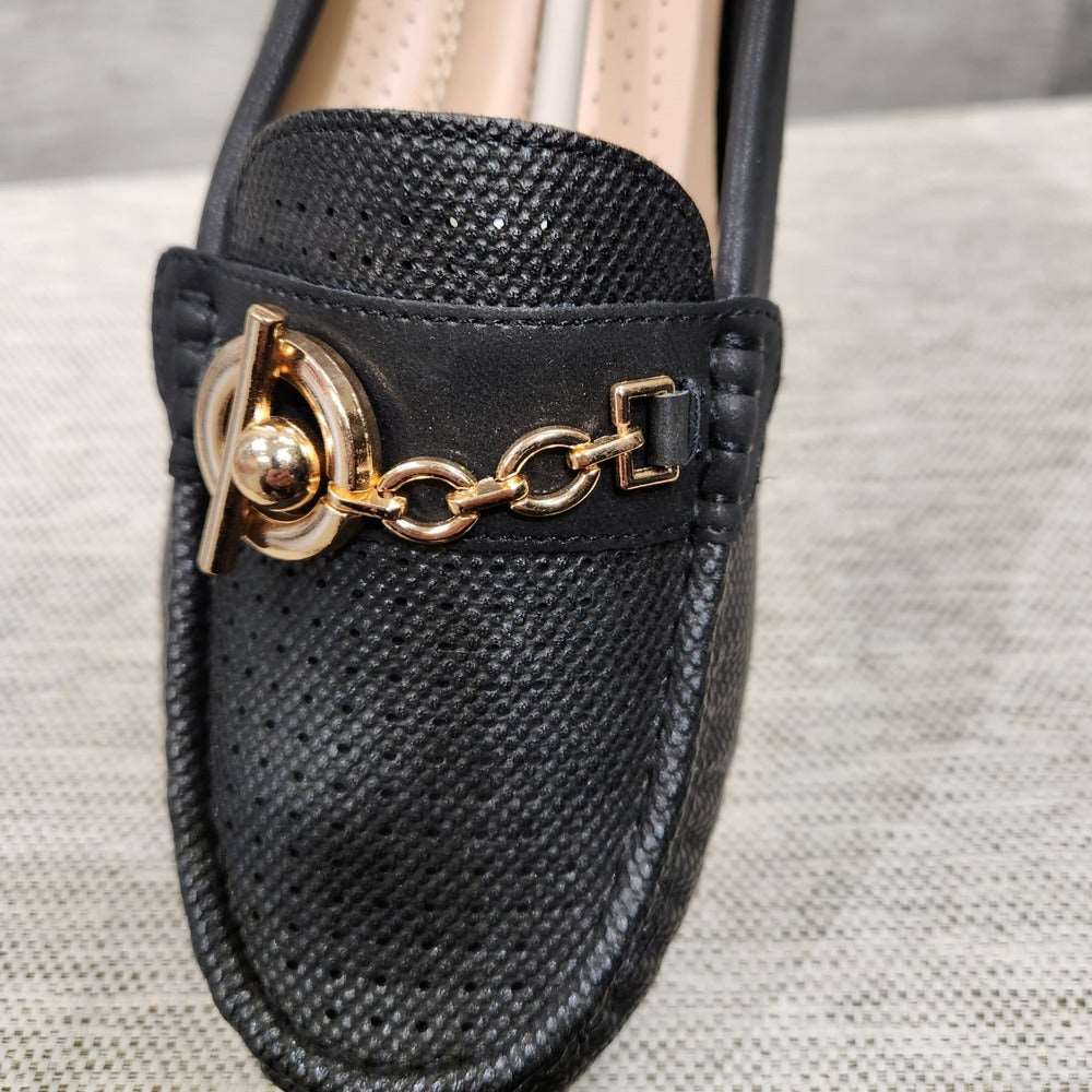 Detailed view of shoe front and gold buckle