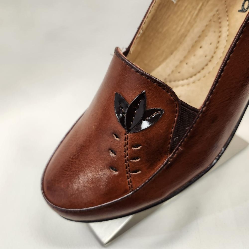Detailed view of tan flat shoes