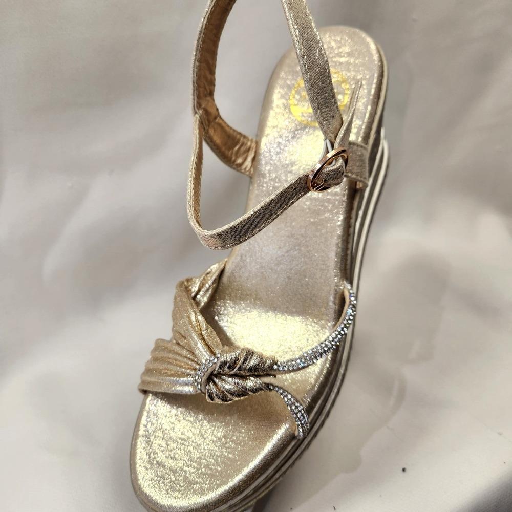 Front view of Gold summer sandal with buckle fastening