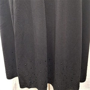 Detailed view of stone embellished hemline